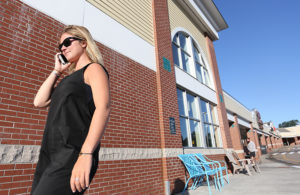 Norwood Plaza shopper on phone